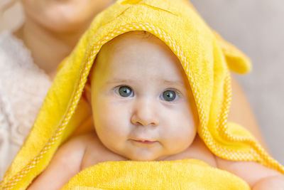 Portrait of cute baby wearing towel at home