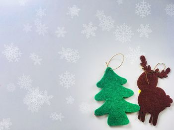 Winter decoration, christmas reindeer with christmas tree, white snowflakes 