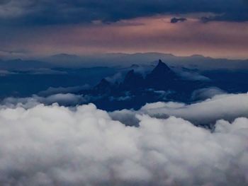 Scenic view of majestic mountains against sky during sunset