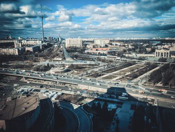 High angle view of highway by buildings in city against sky