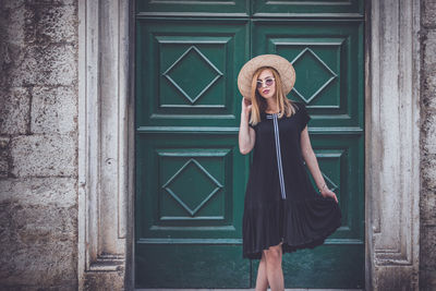 Full length of woman standing in front of door