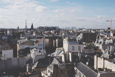 View of cityscape against cloudy sky