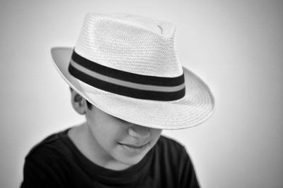 Boy wearing hat against white background