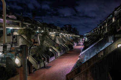 Panoramic view of illuminated row against sky at night