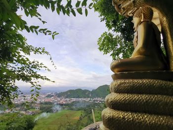Statue of buddha against sky