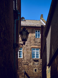 Low angle view of buildings against clear blue sky