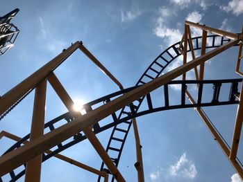 Low angle view of roller coaster against sky