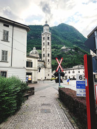 Street amidst buildings in city against sky