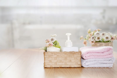 Towels on wooden top table with copy space on blurred bathroom b