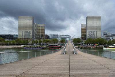 View of bridge over river against cloudy sky