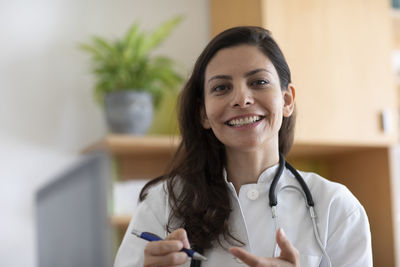 Female doctor with pen and coat in a practice