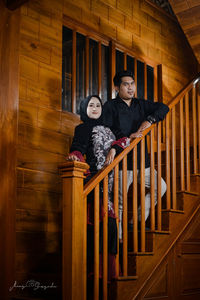 Full length portrait of mother and daughter on staircase