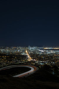 High angle view of illuminated buildings against sky at night