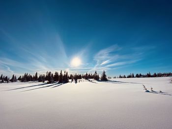 Scenic view of snow covered land against sky