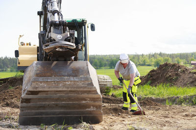 Woman working near digger