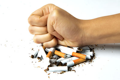 Close-up of hand holding cigarette