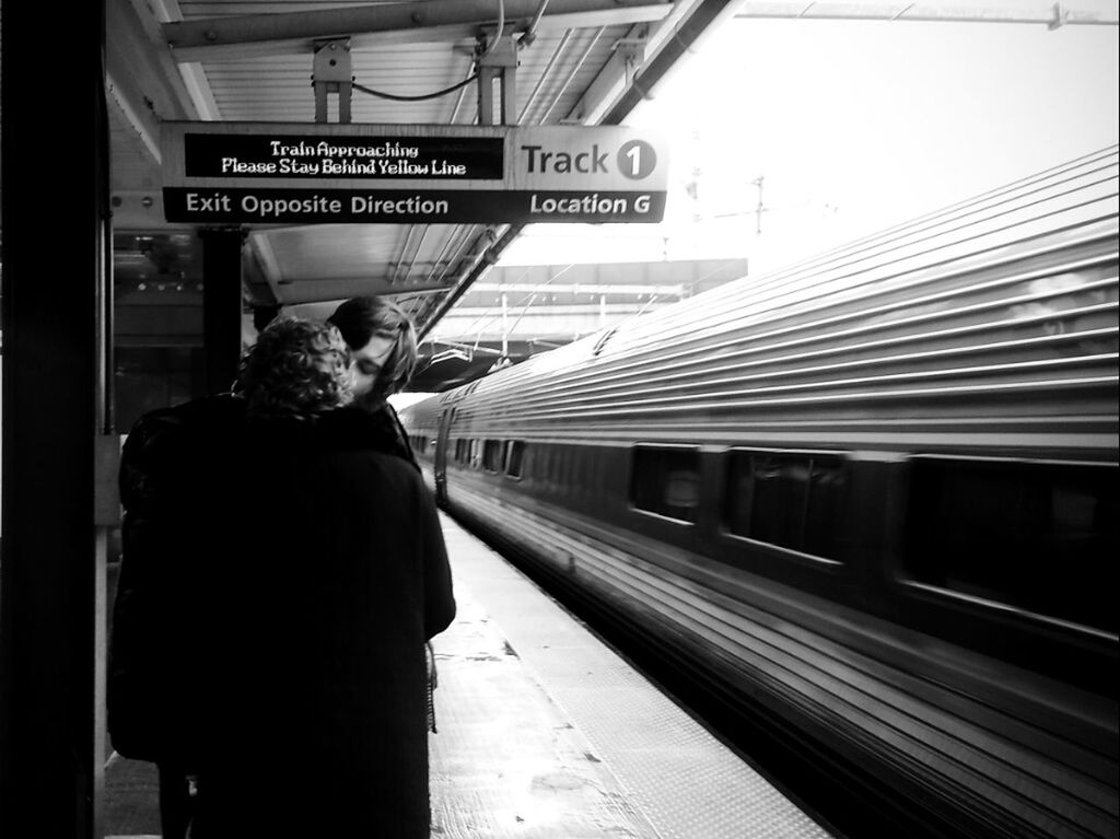 public transportation, railroad station, rail transportation, men, railroad station platform, railroad track, transportation, lifestyles, rear view, text, communication, train - vehicle, passenger train, travel, person, western script, architecture, passenger