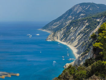 Scenic view of sea and mountains against sky