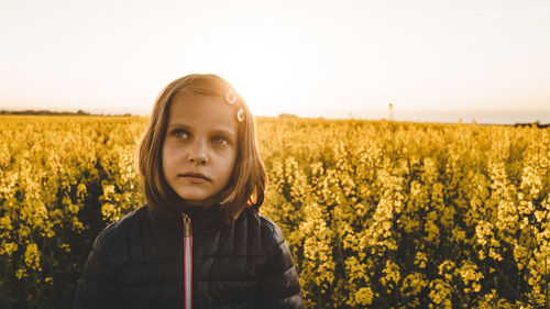 Portrait of beautiful young woman in field