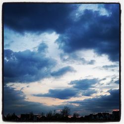 Cityscape against cloudy sky