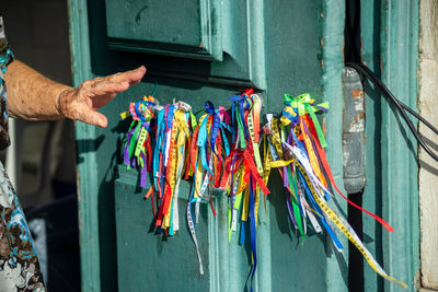 View of the entrance door of the senhor do bonfim church with colorful souvenir ribbons hanging. 