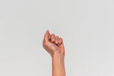 Close-up of person hand against white background