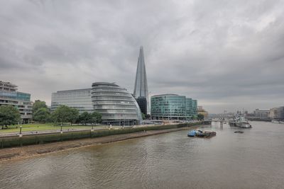 Shard london bridge by thames river against sky in city