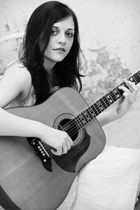 Young woman playing guitar