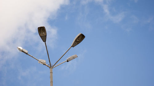 Low angle view of road sign against sky