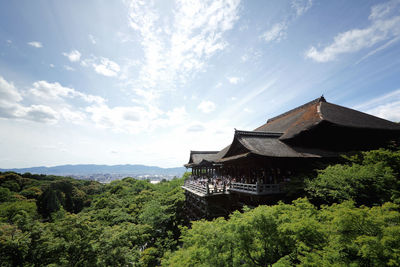 Temple by building against sky