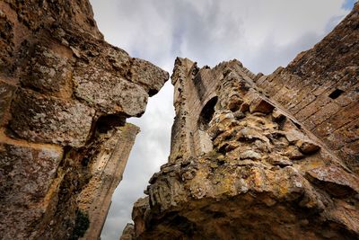 Low angle view of old ruins against sky