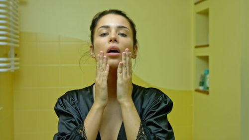 Portrait of woman standing in bathroom
