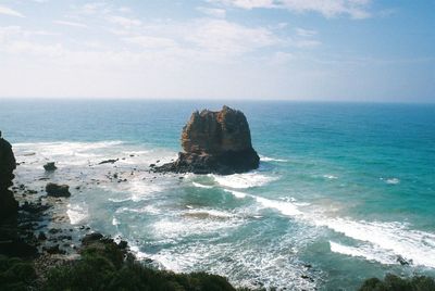 Scenic view of rock formation in sea against sky