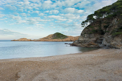 Scenic view of sea and mountains against sky