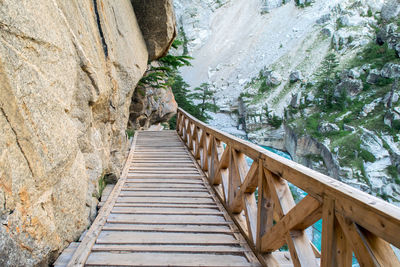 Boardwalk amidst rocks and trees in forest