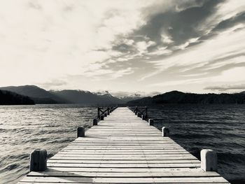 Pier over lake against sky