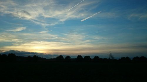 Silhouette of landscape against sky at sunset