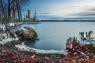 Scenic view of river against sky during winter