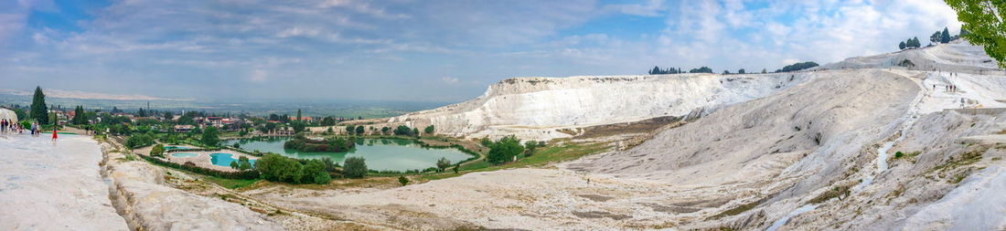 Panoramic view of city against cloudy sky