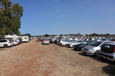 Cars on road against clear blue sky