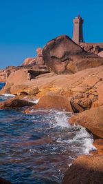 Scenic view of coastline against clear blue sky