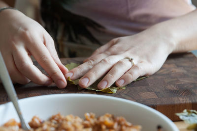 Midsection of woman preparing food in kitchen at home