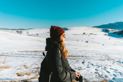 Rear view of woman standing on snow