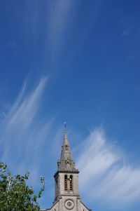 Low angle view of church towel against blue sky