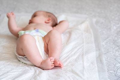 Portrait of cute baby boy sleeping on bed at home