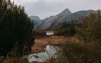 Scenic view of lake and mountains against sky