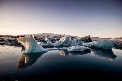 Scenic view of frozen lake against sky during winter