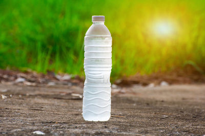 Close-up of white bottle on field