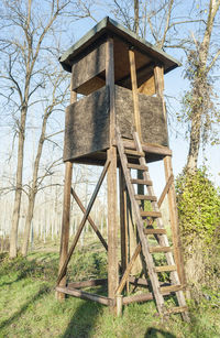 Low angle view of water tower on field against clear sky