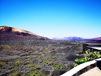 Scenic view of mountains against clear blue sky